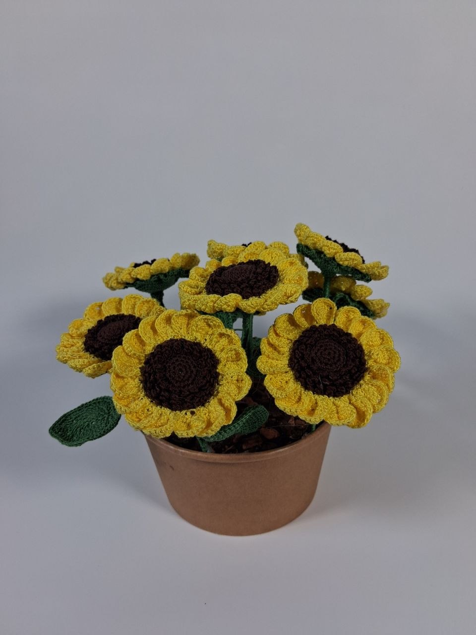 Handmade crochet sunflower arrangement with nine yellow flowers in a brown pot